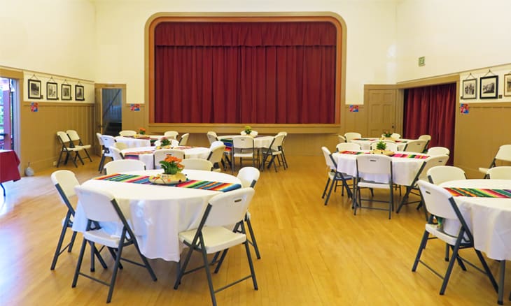 A room with many tables and chairs in it