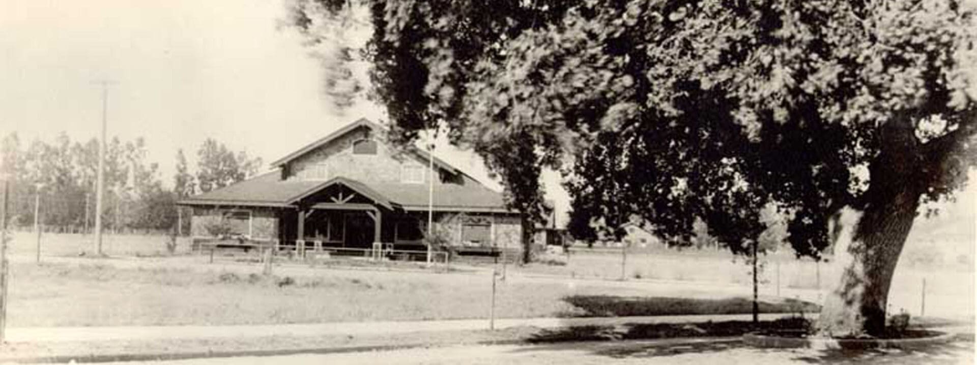 A black and white photo of a house with smoke coming out the windows.