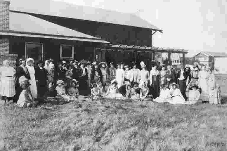 A group of people standing in front of a building.