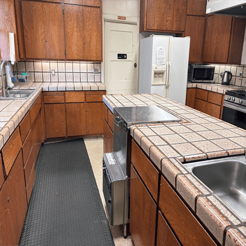 Clubhouse kitchen with sinks, counters and cupboards and a fridge
